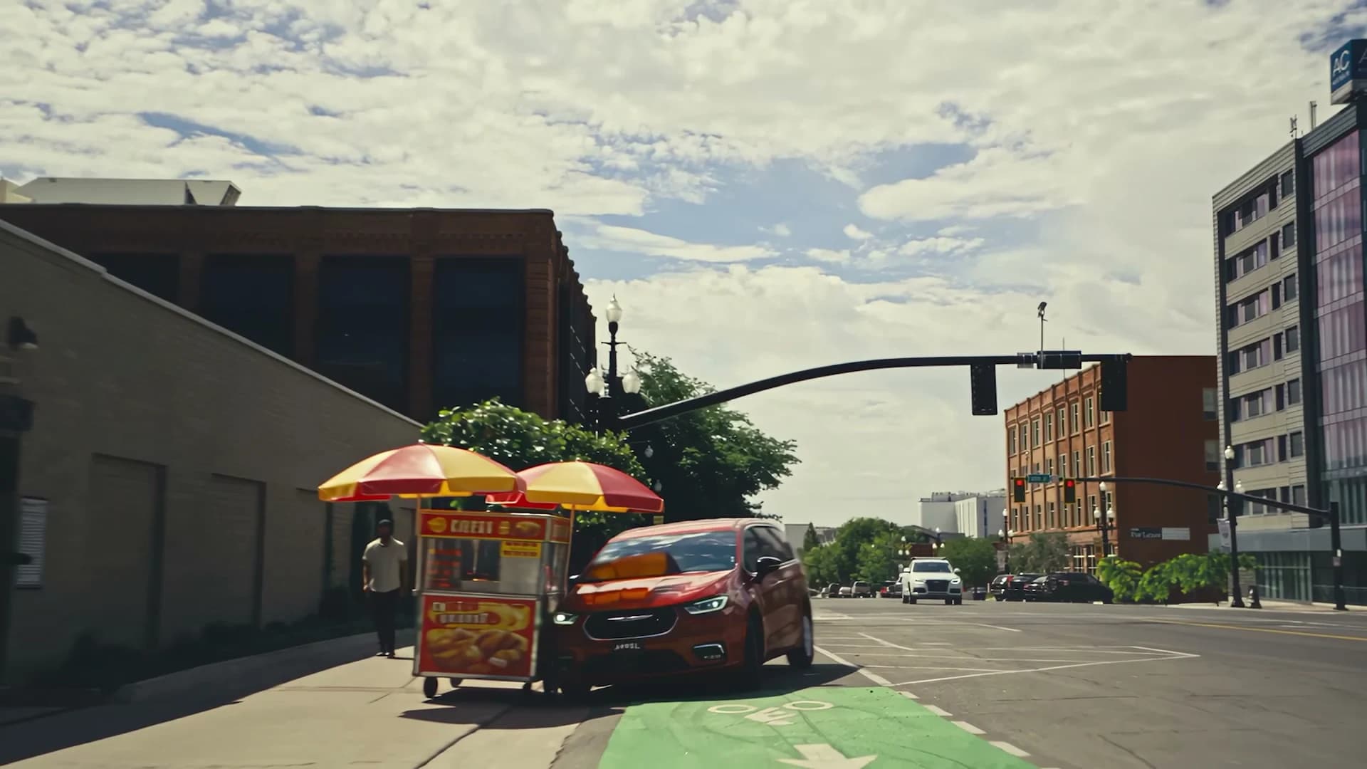 A red car turning through a city intersection in Runner